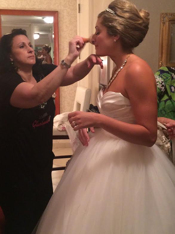 Sylvia putting the finishing touches on our bride, Emily!