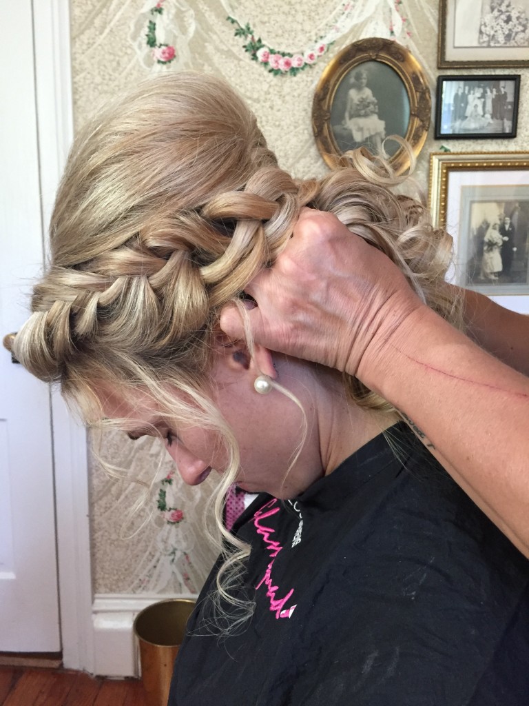 bridesmaid getting her hair done in braided undo