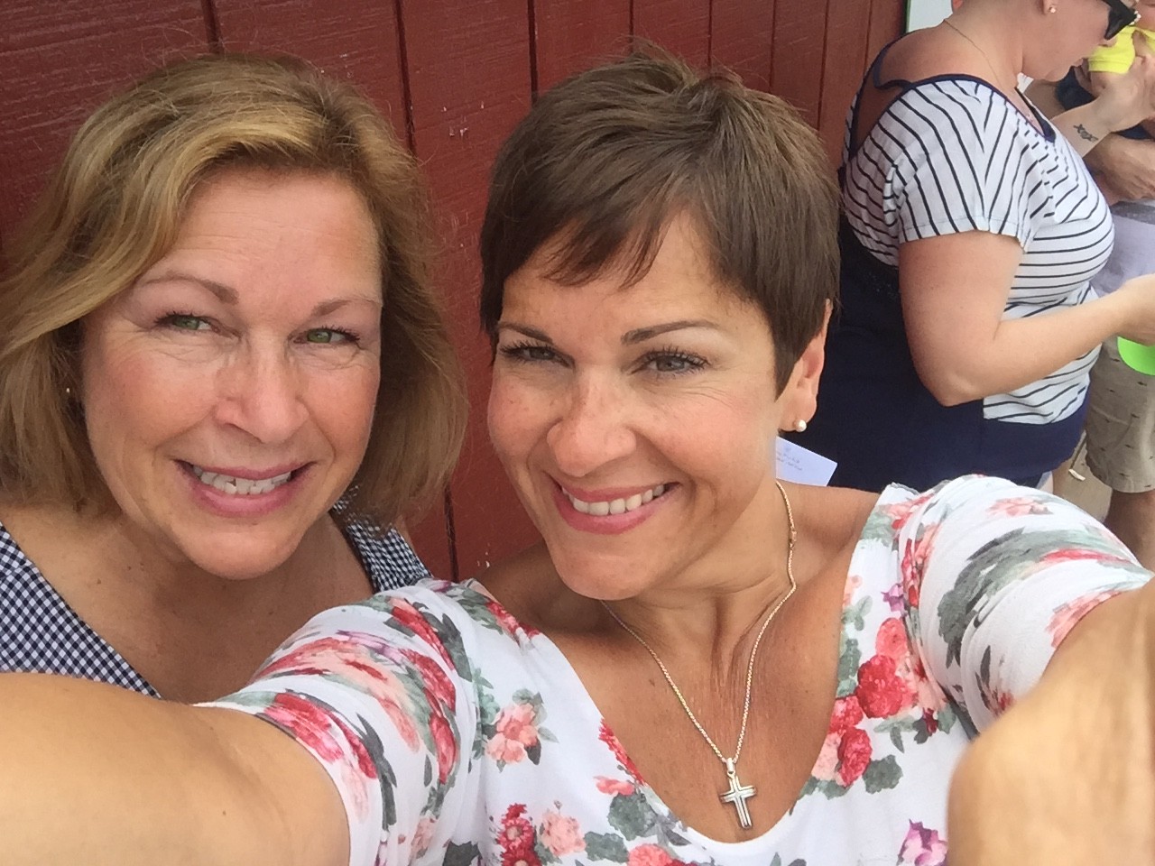 Lou and Sandy snapping a selfie at an outdoor music festival.